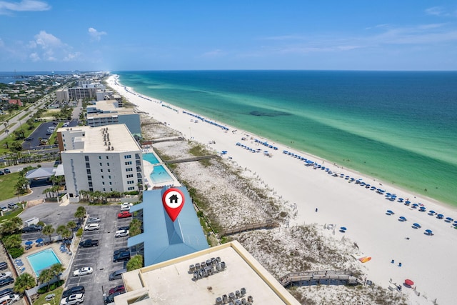 birds eye view of property with a water view and a beach view