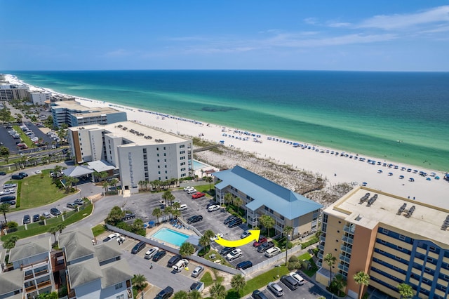 aerial view featuring a view of city, a beach view, and a water view