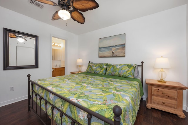 bedroom featuring ensuite bath, baseboards, visible vents, and dark wood-type flooring