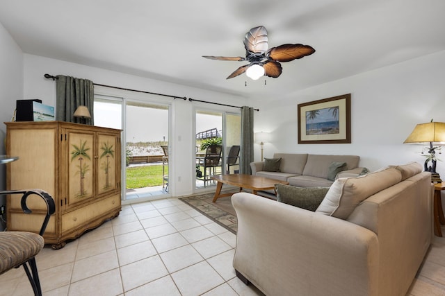 living area with a ceiling fan and light tile patterned flooring