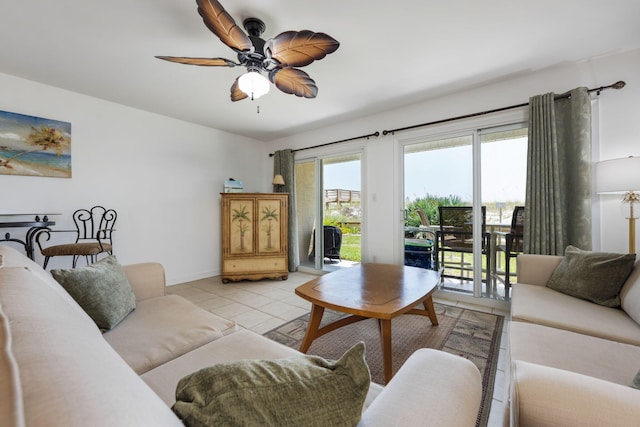 living room with light tile patterned floors, baseboards, and a ceiling fan