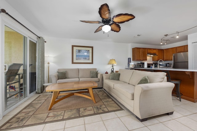 living area featuring light tile patterned floors, ceiling fan, and visible vents