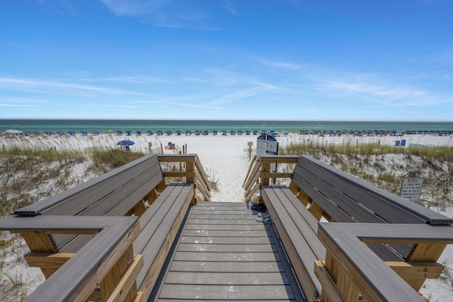 view of home's community featuring a beach view and a water view