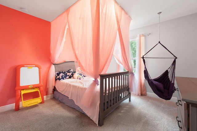 carpeted bedroom featuring baseboards