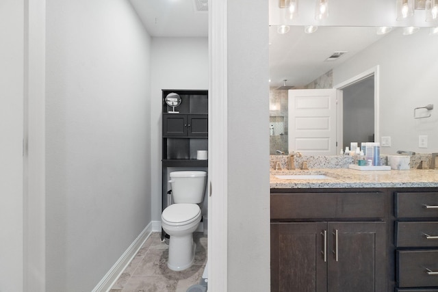 full bathroom featuring baseboards, visible vents, vanity, and toilet