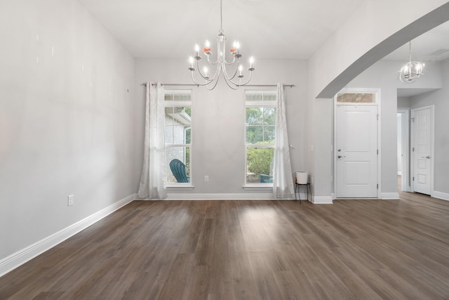 interior space with an inviting chandelier, baseboards, and wood finished floors