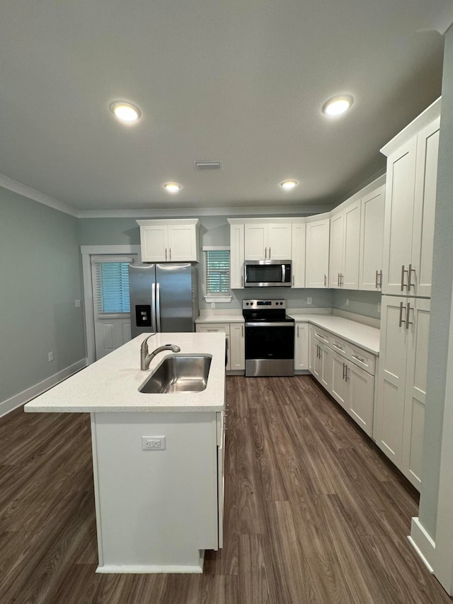 kitchen with sink, ornamental molding, dark hardwood / wood-style flooring, white cabinetry, and stainless steel appliances