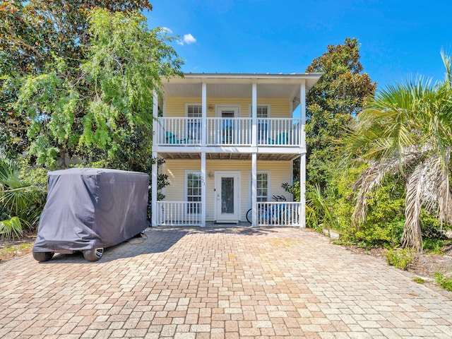 view of front of property featuring a porch and a balcony