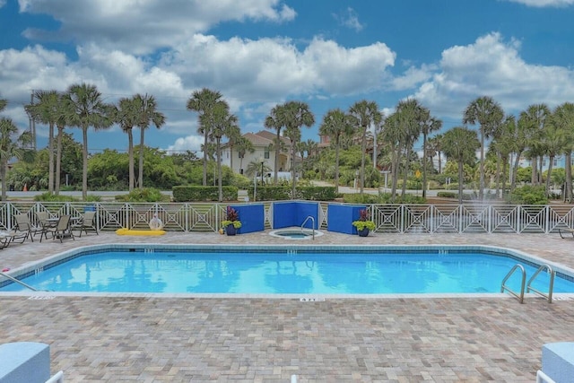 pool with a community hot tub and a patio