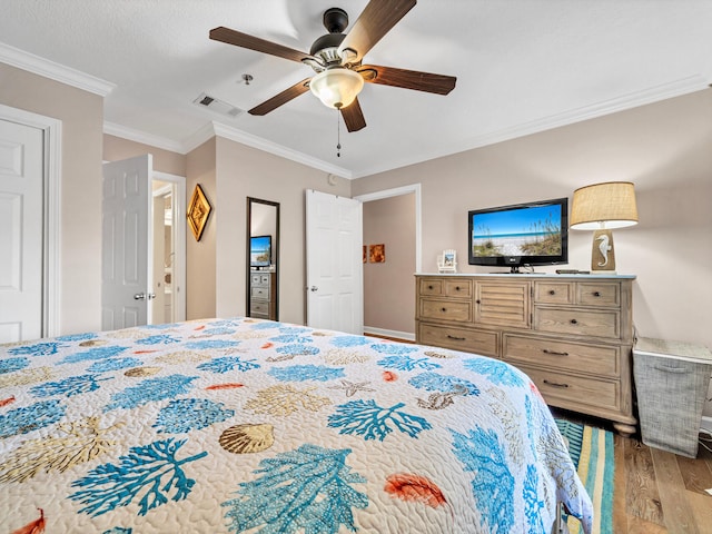 bedroom with ceiling fan, ornamental molding, visible vents, and light wood-style floors