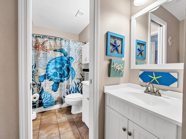 full bath with visible vents, vanity, toilet, and tile patterned floors