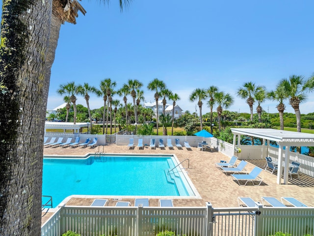 pool featuring a patio area and fence