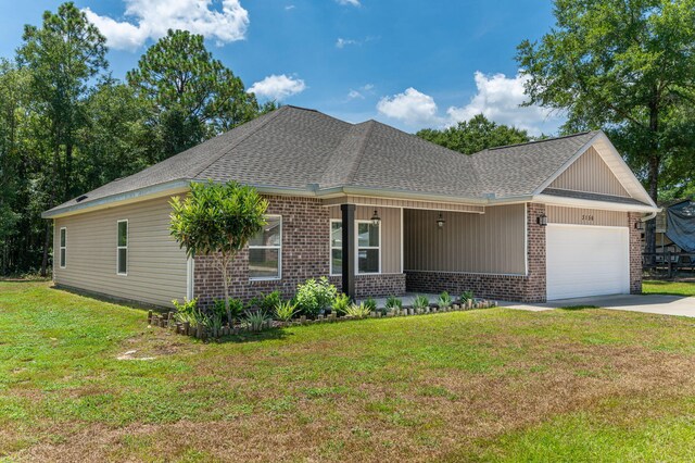 view of front of property with a garage and a front lawn