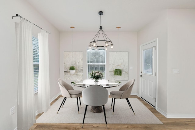 dining space featuring a notable chandelier and hardwood / wood-style flooring