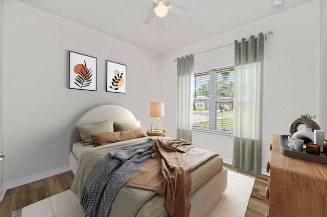 bedroom with light wood-type flooring and ceiling fan