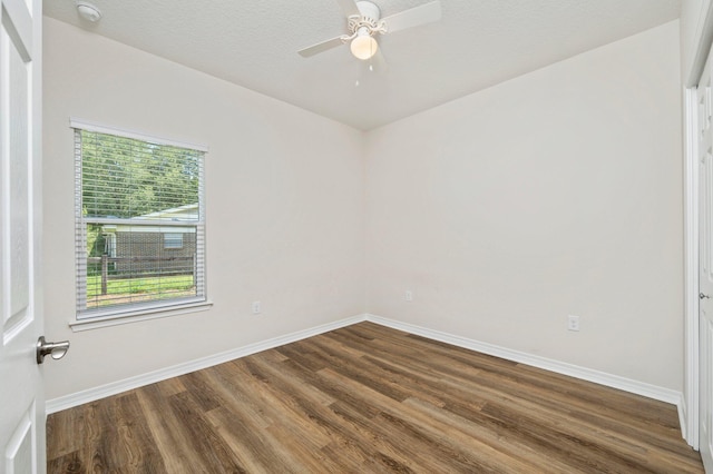 empty room featuring ceiling fan and dark hardwood / wood-style flooring