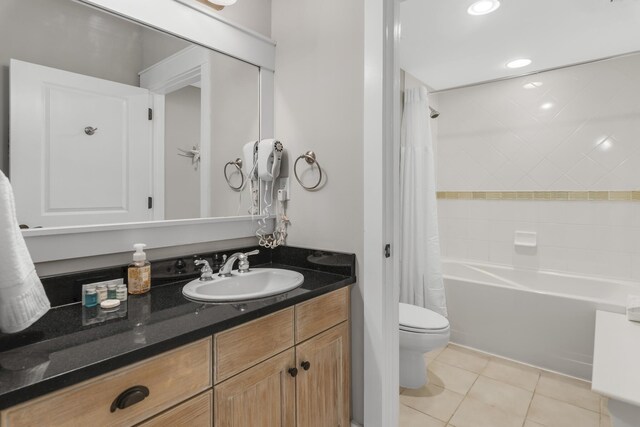 full bathroom with shower / bathtub combination with curtain, toilet, vanity, and tile patterned floors