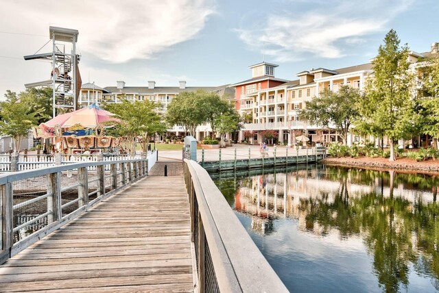 view of dock with a gazebo and a water view