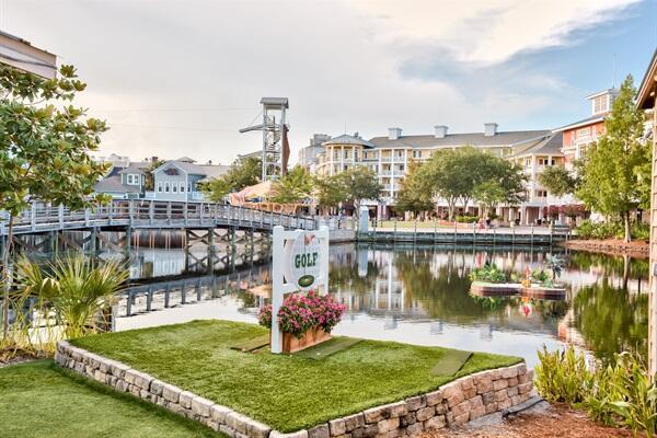 surrounding community with a yard, a boat dock, and a water view