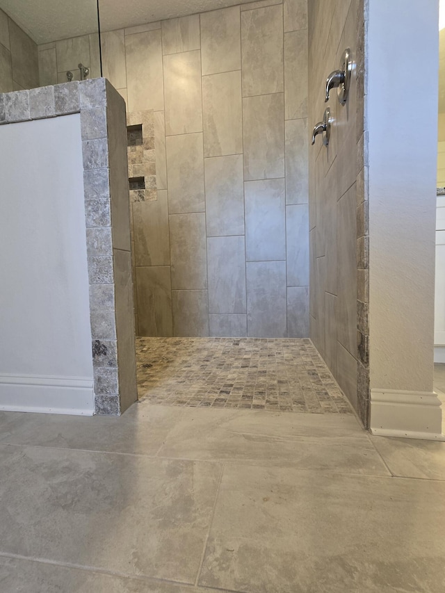 bathroom with tiled shower