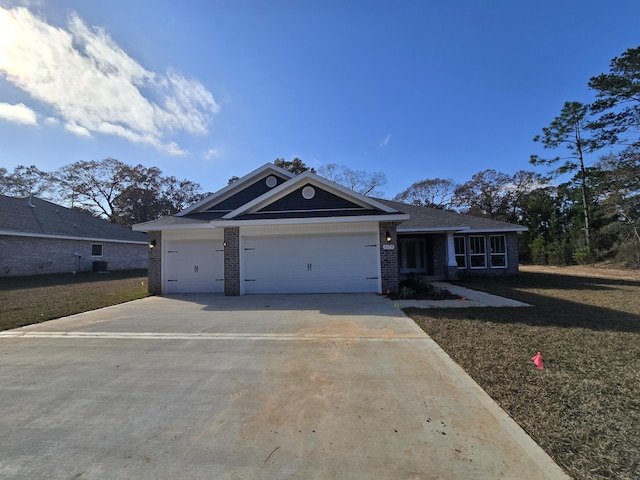 view of front of home featuring a front yard and a garage