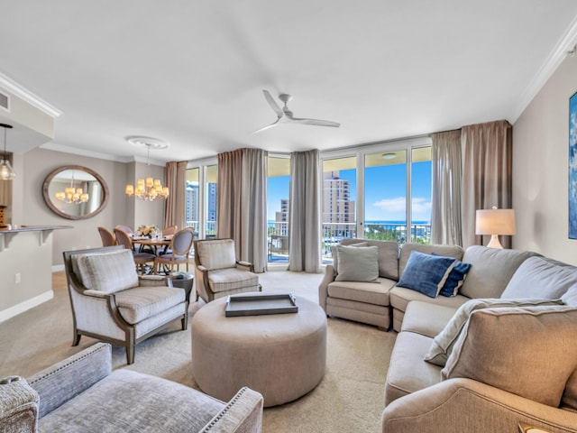 carpeted living room featuring ceiling fan with notable chandelier, expansive windows, and crown molding