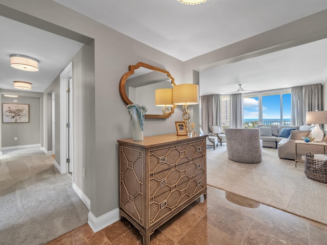 corridor featuring carpet floors and baseboards