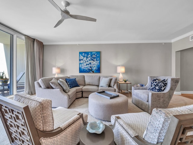 living room with a ceiling fan, visible vents, crown molding, and baseboards