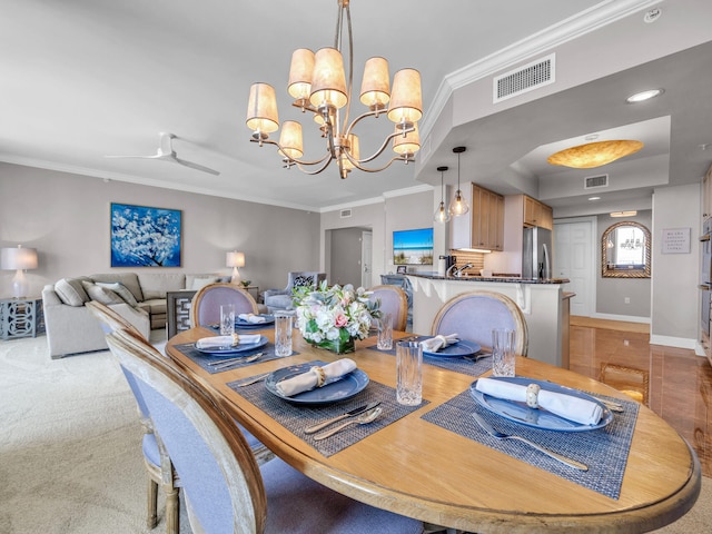 dining room featuring baseboards, ceiling fan with notable chandelier, visible vents, and ornamental molding