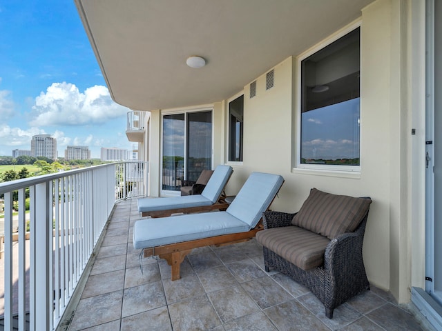 balcony with visible vents and a city view