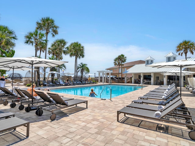 pool with a patio and fence