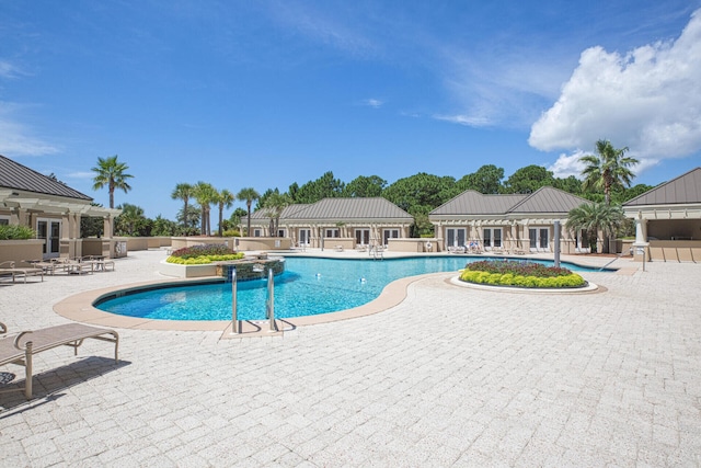 community pool with fence, a pergola, and a patio