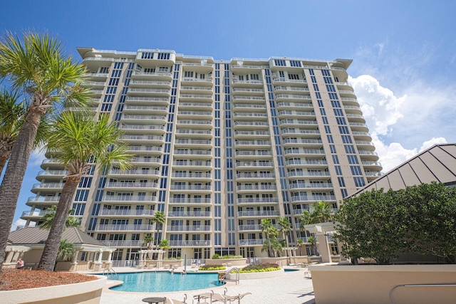 view of building exterior featuring a community pool