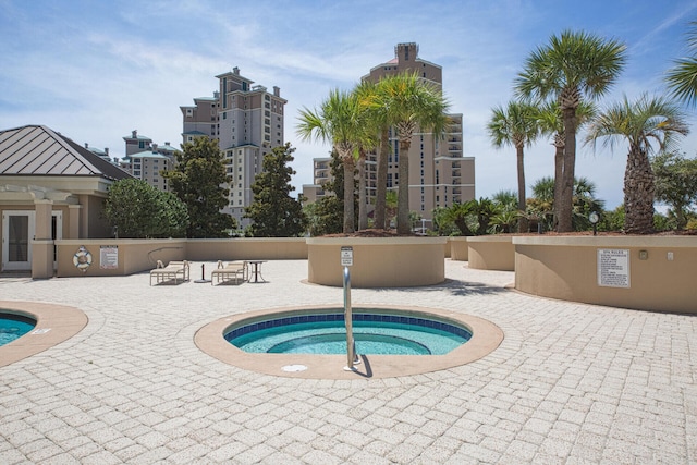 view of swimming pool featuring a patio area and a community hot tub