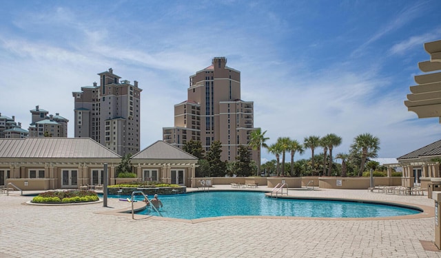 pool with fence, a patio, and french doors