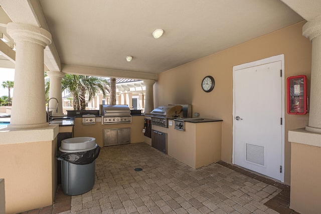 view of patio / terrace with a sink, area for grilling, a grill, and visible vents