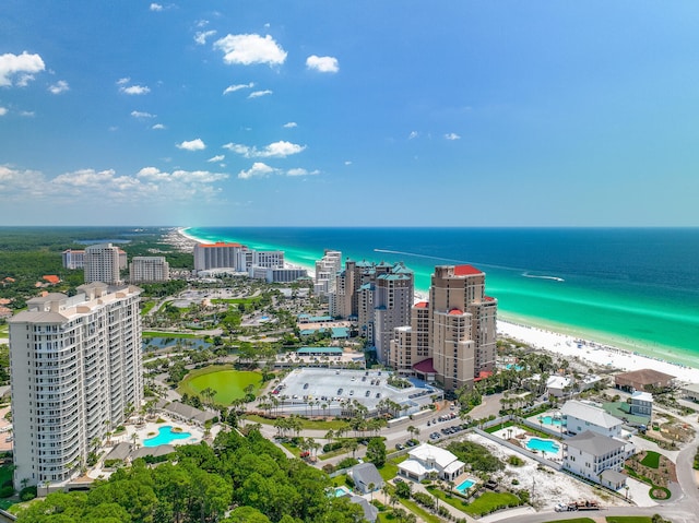 drone / aerial view with a water view, a beach view, and a city view