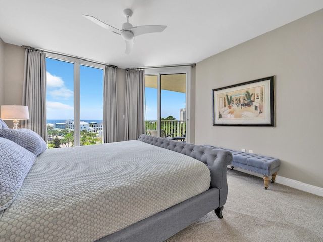 bedroom with carpet, access to outside, multiple windows, and baseboards