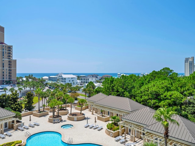 pool featuring a water view, a patio area, and a community hot tub