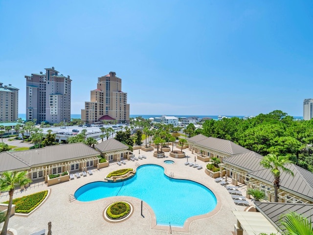 community pool featuring a view of city and a patio