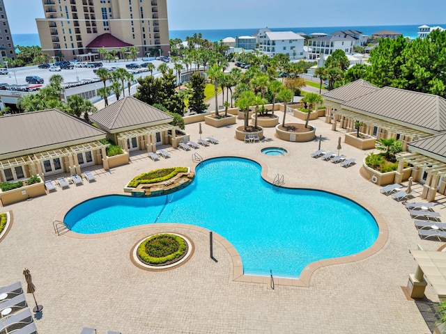 pool with a water view and a patio area