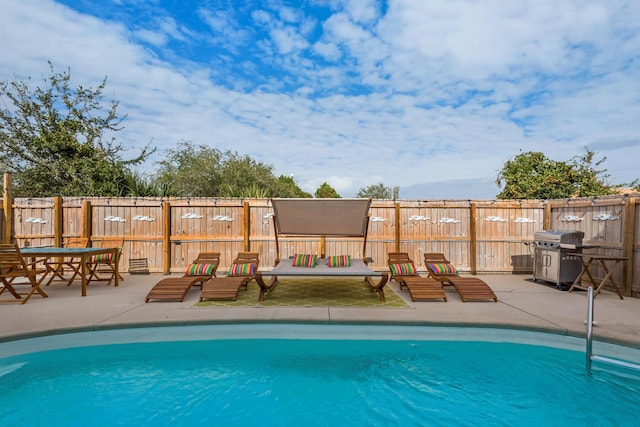 view of pool featuring a fenced in pool, area for grilling, fence, and a patio