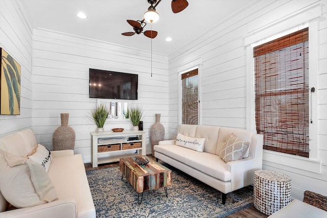 living room with ceiling fan, wood finished floors, recessed lighting, and ornamental molding