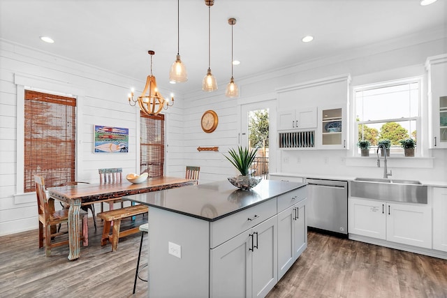 kitchen featuring stainless steel dishwasher, a wealth of natural light, a sink, and an inviting chandelier