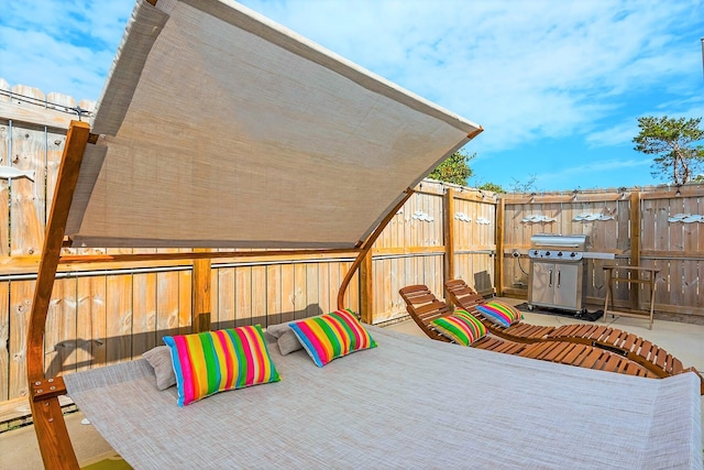 view of patio / terrace featuring grilling area and fence