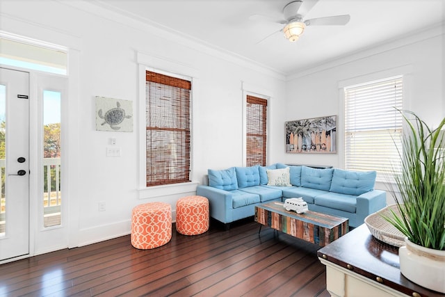 living area featuring dark wood-type flooring, ornamental molding, baseboards, and ceiling fan
