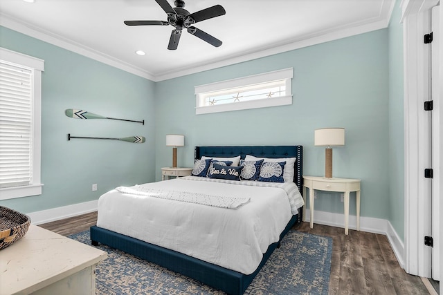 bedroom featuring a ceiling fan, crown molding, baseboards, and wood finished floors