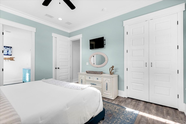 bedroom featuring ornamental molding, baseboards, ceiling fan, a closet, and wood finished floors