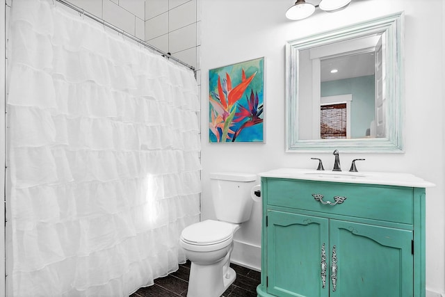 full bath featuring baseboards, wood finished floors, toilet, and vanity