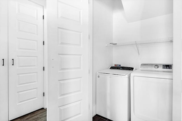 laundry area featuring independent washer and dryer, dark wood-style flooring, and laundry area